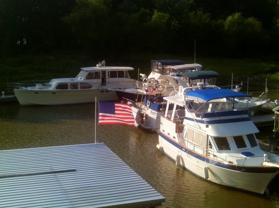 American flag with boats docked at the marina